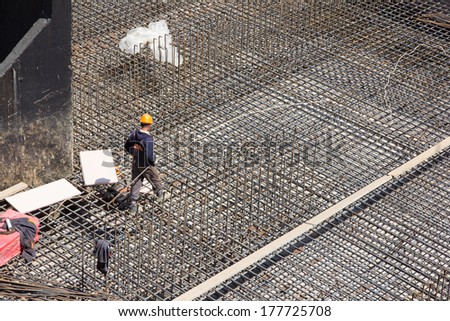 workers make metal reinforcement for the concrete foundation