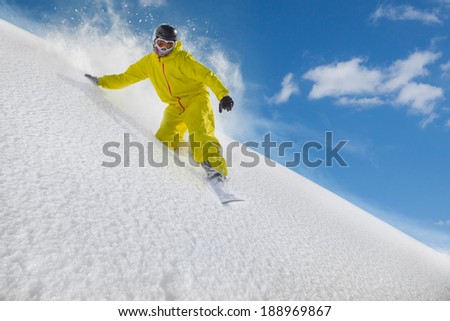 Snowboard freerider moving down in snow powder