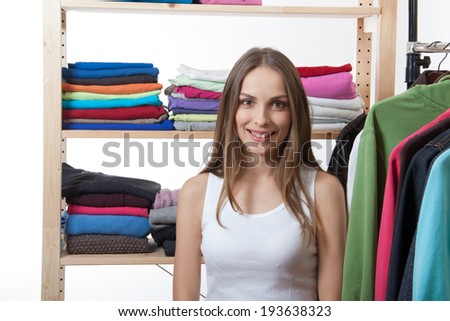 young woman chooses clothes, isolated on white background