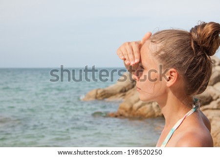 woman looks into the distance