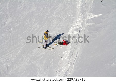 Accident on the mountain ski slope, fallen skier