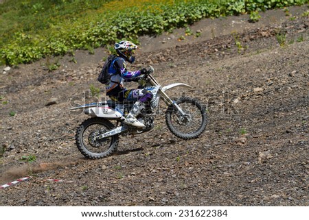 SOCHI, RUSSIA -AUGUST 16, 2014: Off-road motorcycle rider trains in summer mountains
