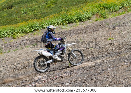 SOCHI, RUSSIA - AUGUST 16, 2014: Off-road motorcycle rider trains in summer mountains