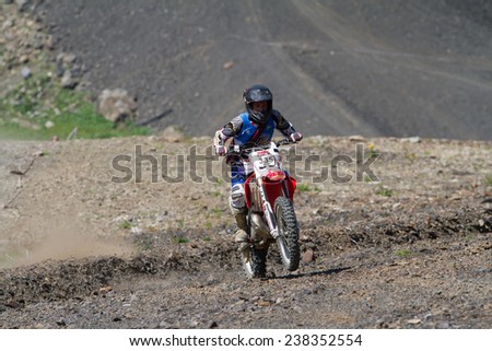 SOCHI, RUSSIA  AUGUST 16, 2014: Off-road motorcycle rider trains in summer mountains