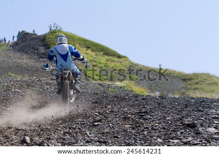 SOCHI, RUSSIA - AUGUST 16, 2014: Off-road motorcycle rider trains in summer mountains