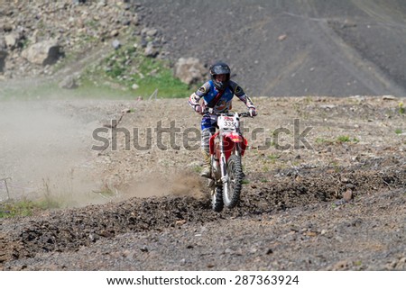 SOCHI, RUSSIA â?? AUGUST 16, 2014: Off-road motorcycle rider trains in summer mountains