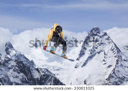 Flying snowboarder on mountains, extreme winter sport