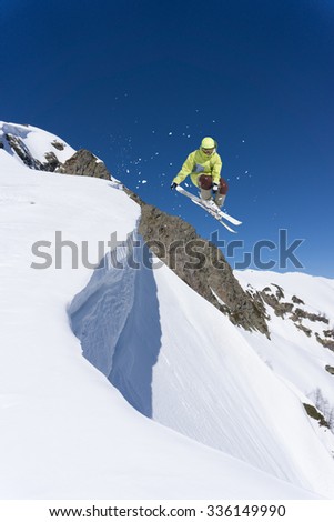 Flying skier on mountains, winter extreme sport