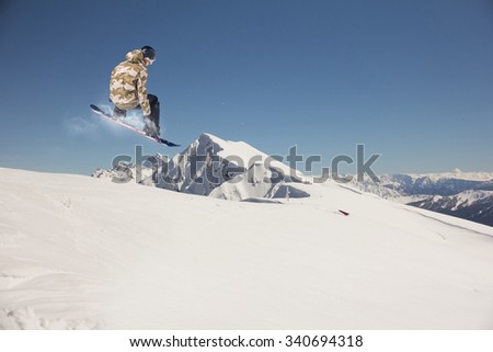 flying snowboarder on mountains. Extreme winter sport