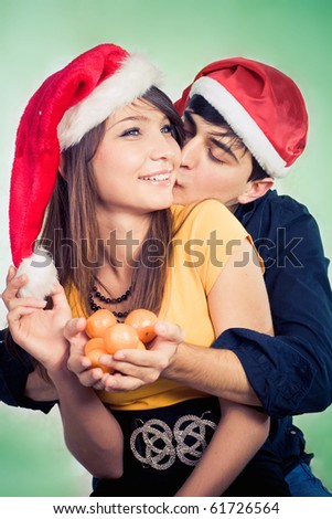 man surprising woman with tangerine