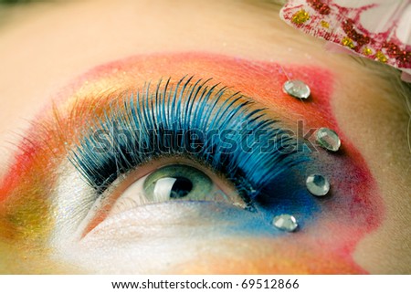 Female eye with rainbow make-up and long eyelashes