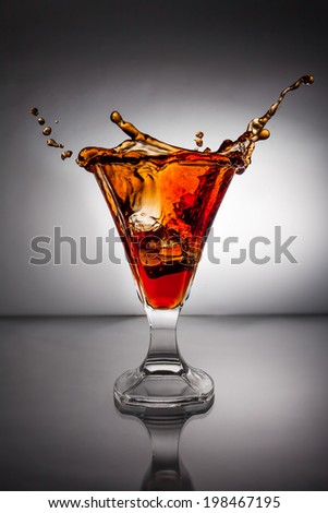 Glass with whiskey splash