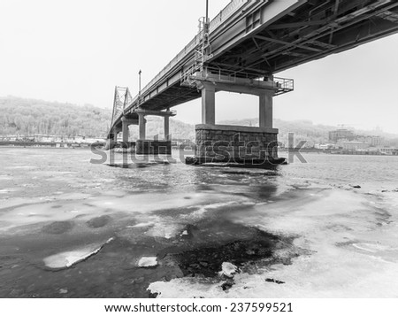 Footbridge in Kiev and frozen river in the ice