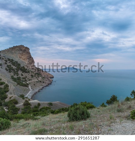 Dawn at Black sea. Morning seascape with mountains.