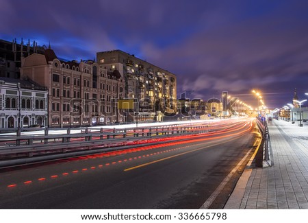 Car light trails and urban landscape. Moving car with blur light through city at night. Kiev city, Ukraine.
