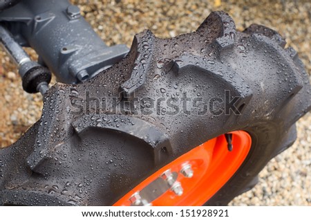 Wet tractor tire on ground