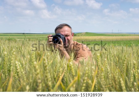 Photographer in action in the wheat field