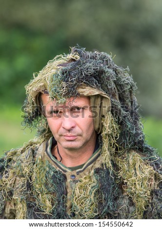 Portrait of camouflaged man in forest
