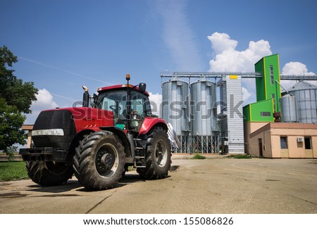 Truck parked in front of grain silos