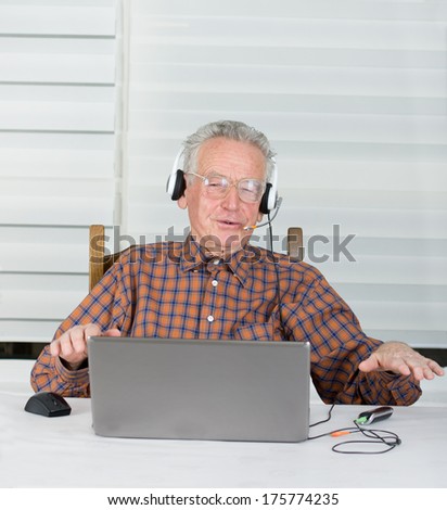 Senior man listen music from laptop and make some rap movements