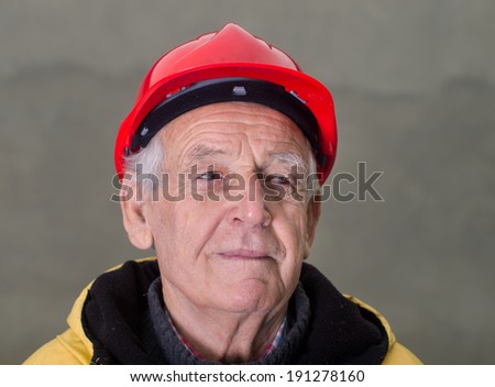 Portrait of senior engineer with red helmet