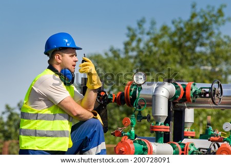 Worker with safety equipment on oil plant
