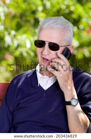Old man smiling and talking on cell phone