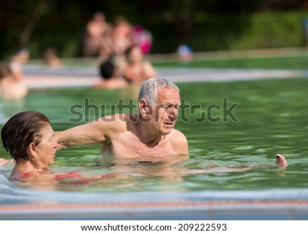 Senior couple enjoying holiday in the pool with hot water