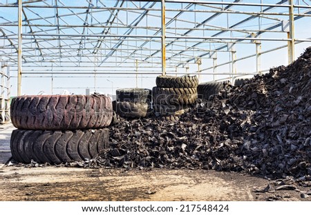 Close up of old used tires and shredded tire pile