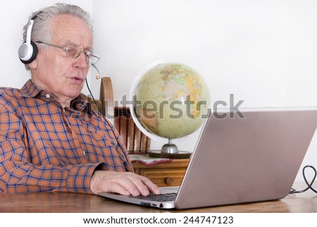 Older man using laptop for internet communication