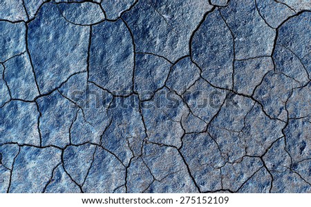 Abstract texture of blue cracked dirt as background