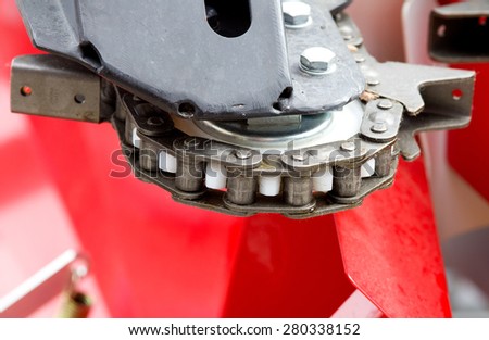 Close up of chain on gear on agricultural machine