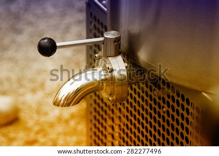 Close up of faucet on milk cooling tank in dairy plant