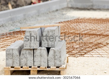 Kerb stones on palette placed at gravel ground at road construction site