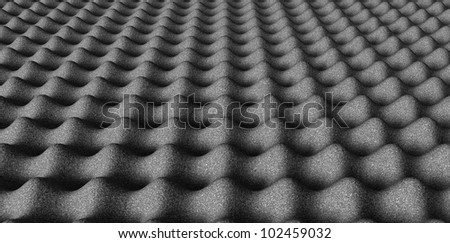 A perspective view of grey sound proofing foam in a square pattern