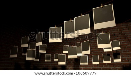 A gallery of blank polaroids pegged onto multi-directional red strings in front of a face brick wall