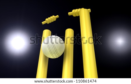A white leather cricket ball hitting yellow cricket wickets in the nighttime