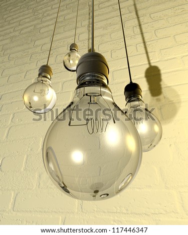 Four regular unlit light bulb fitted into light fittings hanging from chords on a white washed brick wall