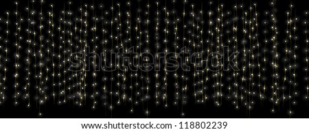 A curtain of illuminated fairy lights on a dark isolated background