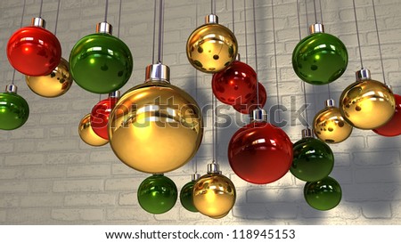 Regular gold red and green christmas baubles hanging by a string against a white wash brick wall