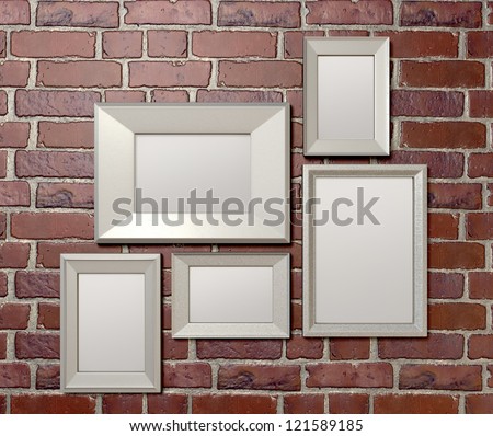 A front view of an arrangement of five blank metal picture frames hanging on a red clay brick  brick wall