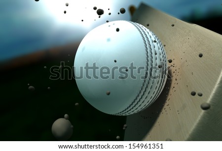 A white leather stitched cricket ball hitting a wooden cricket bat with dirt particles emanating from the impact at night