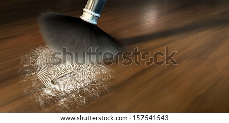 A crime scene brush dusting black talcum powder revealing and a fingerprint mark on a wooden surface