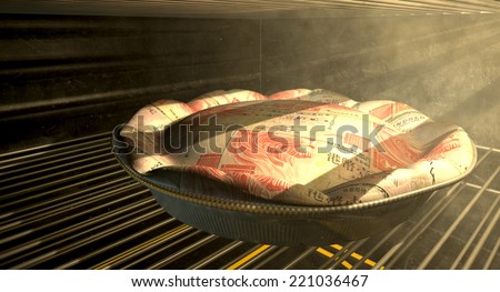 A closeup concept of a money pie made with Hong Kong Dollar bank notes baking in a heated oven