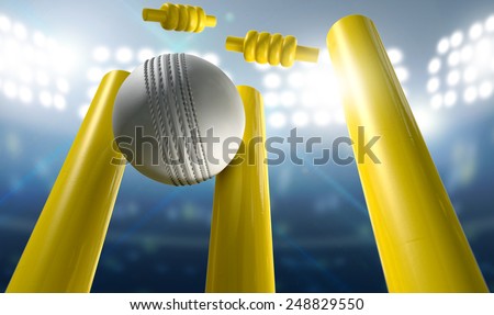 A white leather cricket ball hitting yellow wooden cricket wickets on a floodlit stadium background at night