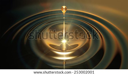 An extreme close up of a drop of oil creating ripples on an isolated black background
