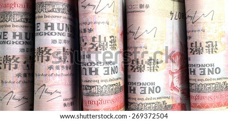 A close-up view of five wads of folded over stacks of norwegian kroner banknotes each bound informally by a rubber band set out in a domino formation on an isolated white studio background