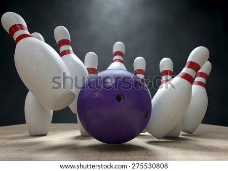 An arrangement of white and red used vintage bowling pins being struck by a bowling ball on a wooden bowling alley surface on a dark background