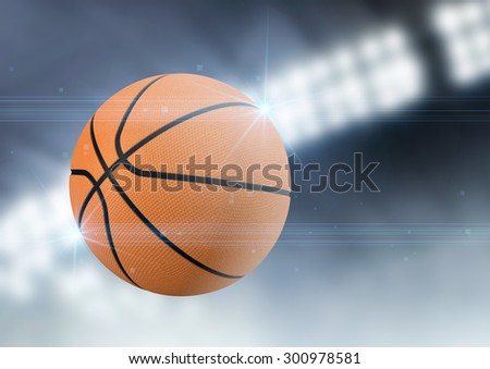A regular basketball flying through the air on an indoor stadium background during the night