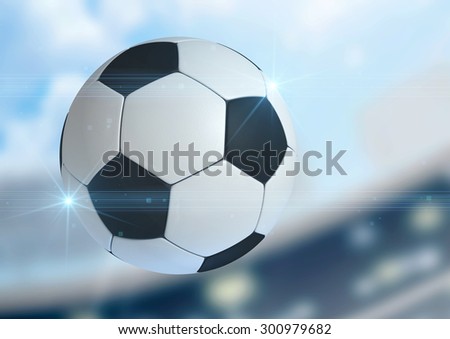A regular soccer ball flying through the air on a stadium background during the daytime